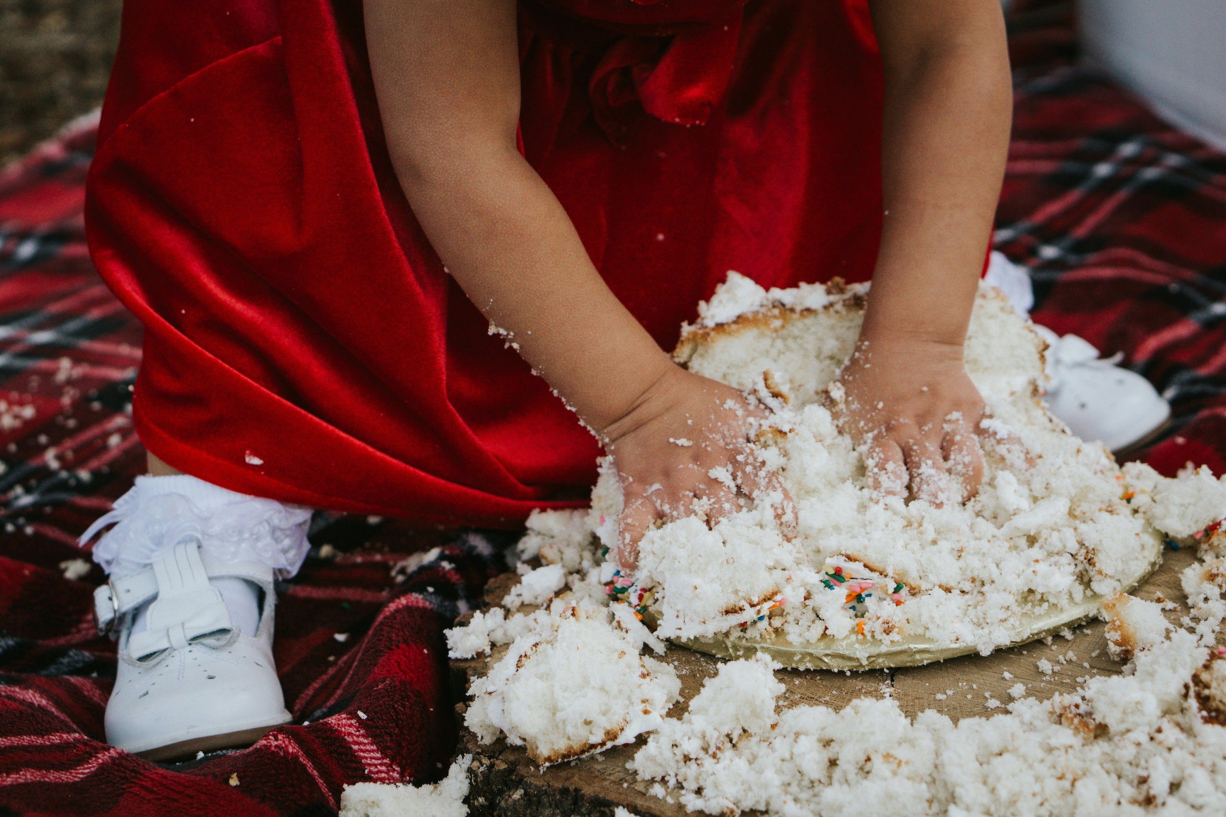 Little girl smashing a wedding cake